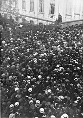 Philipp Scheidemann addresses a crowd from a window of the Reich Chancellery, 9 November 1918. Bundesarchiv B 145 Bild-P011502, Berlin, Reichskanzlei, Philipp Scheidemann.jpg