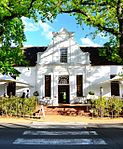 La Gratitude was built by the Rev. Meent Borcherds, the parson at Stellenbosch from 1786 to 1830, in 1798. He was born at Jangum, East Friesland, in 1762. The house is a U-shaped building with one of the earliest neo-classical pilaster-gables. The pilasters are repeated between the windows. This gives an exceptional dignity to the facade and creates an air of aristocratic pride.