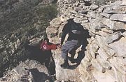 Hikers on the steep one hundred foot drop trail in Indian Mesa.