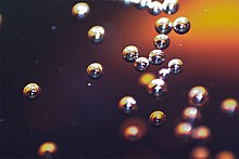 Carbon dioxide bubbles in a soft drink Soda bubbles macro.jpg