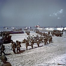 Canadian reinforcements arrive on Juno Beach during the Normandy landings in 1944. The taking of Juno Beach was primarily the responsibility of the Canadian Army. Soldats de l'infanterie canadienne est en train de debarquer sur les plages de Juno Beach.jpg