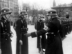 The 1st SS Panzer Division Leibstandarte SS Adolf Hitler (LSSAH) in their black uniforms. Bundesarchiv Bild 183-H15390, Berlin, Kaserne der LSSAH, Vergatterung.jpg