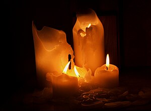 Picture of several candles melting in the dark...