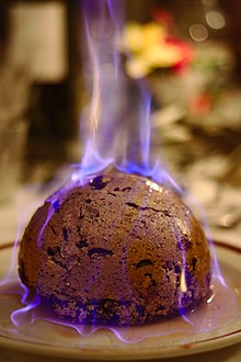 Many traditions enjoy dessert after the main course. Here, a Christmas pudding is set aflame after brandy has been poured on it. Christmas pudding (Heston from Waitrose) flaming.jpg