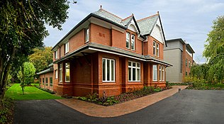 Ein rotes, größeres Haus mit Garten, Edge Hill University Hollies Wohnheim