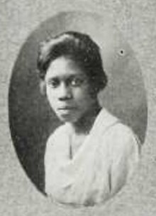 A young black woman wearing a white top, from a 1919 yearbook.