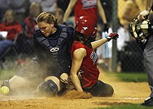 A collision at home plate -- the player in red scores as the catcher has failed to secure the ball. Softball home plate collision -1507299.jpg