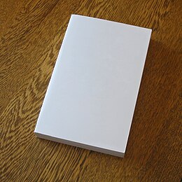 A blank paperback book Blank book on a table.jpg