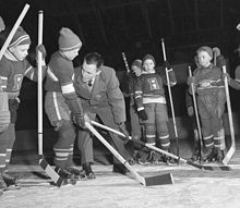 Coach demonstrating skill to players