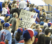 A fan holds a sign that reads "BRING BACK EXPOS".
