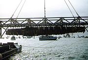 H. L. Hunley, suspended from a crane during its recovery from Charleston Harbor, August 8, 2000. (Photograph from the U.S. Naval Historical Center.)