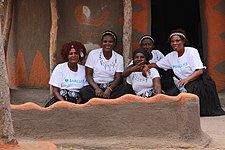 Hosanas_in_front_of_a_thatched_traditional_house_at_Domboshaba_cultural_festival