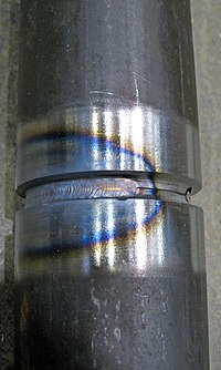 The blue area results from oxidation at a corresponding temperature of 600 °F (316 °C). This is an accurate way to identify temperature, but does not represent the HAZ width. The HAZ is the narrow area that immediately surrounds the welded base metal.