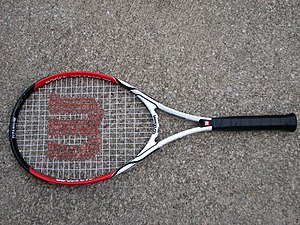 A Wilson brand tennis racquet with a Roger Fed...