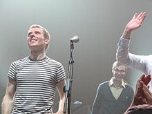 Murdoch with Belle and Sebastian in 2010 at the Wang Theatre in Boston Belle & Sebastian @ Wang, Boston, MA (5102789054).jpg