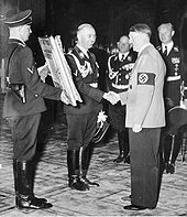 Reichsfuhrer-SS Heinrich Himmler presenting Hitler with a gift Bundesarchiv Bild 183-H28988, 50. Geburtstag Hitler, Gratulation Himmler crop.jpg