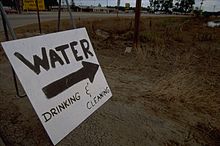 A sign indicating a relief camp providing water for cleaning and drinking