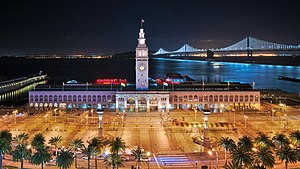 San Francisco Ferry Building, The Embarcadero, and the Bay Bridge at night, all examples of infrastructure Ferry Building at night.jpg