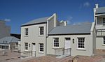 A double storey dwelling recently renovated. These double-storeyed semi-detached houses with their Victorian and Georgian features were erected shortly after the turn of the century. These in Donkin Street, situated opposite the Donkin Reserve, form part of a unique row of terrace houses in the Vict[clarification needed] Architectural style: Victorian townhouse. Type of site: House.