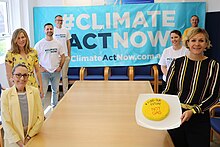 Steggall in 2020 with Climate activists in her electorate office, holding a cake.