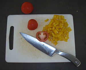 English: Plastic cutting board with slices of ...