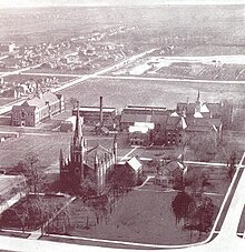 An aerial photograph of the Assumption College campus in 1928. A few buildings are visible with lots of empty field space.