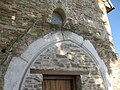 W end Gothic arch with original window above.