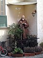 A sculpture of Padre Pio in a garden in Naples