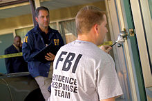 An FBI Evidence Response Team gathering evidence by dusting an area for fingerprints FBI Evidence Response Team.jpg