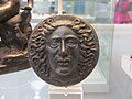 Bronze disc with the head of Apollo Helios