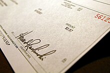 A check, used as a means of converting funds in a demand deposit to cash Sweet success.jpg