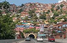 Picture of a shanty town over "La Planicie" tunnel, created because of the rural flight to Caracas. Barrio de Caracas.jpg