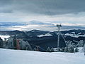 Vedere asupra Țării Bârsei din vârful Postăvaru. Ghimbav este în dreapta, iar Codlea se vede în depărtare Munții Măgura Codlei.