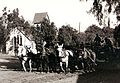 Central Ave, Sierra Madre CA in 1904. A mule team is grading the Ave for the installation of the 1905 Pacific Electric street car, in front of Sierra Madre Memorial Park, the background is the Old North Church with the original barn roof bell tower.