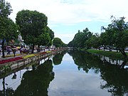 Looking south along a moat in Chiang Mai. The section pictured here forms the eastern border of Amphoe Muang. The road visible on the right is Moon Muang, on the left, Chaiya Poon.