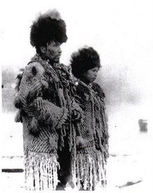 "Black an white photograph of Skwxwu7mesh Chief George from the village of Senakw with his daughter in traditional regalia."