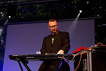 A photo of Rhys Fulber performing with Conhure One in Germany, 2015.