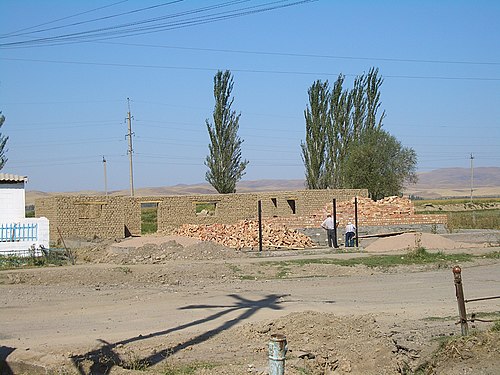 A house under construction in Milyanfan village, apparently with both adobe bricks and regular bricks being used.
