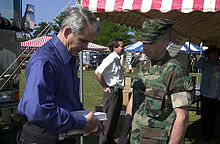 North in April 2002, autographing one of his books for a U.S. Marine Staff Sergeant OliverNorthBookSigning.jpg