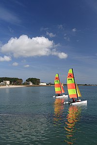 Two catamaran sailboats, leaving Saint-Vaast Harbour