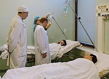 President Vladimir Putin visiting the Sklifosovsky Emergency Medicine Institute to meet with hostages rescued from the theater in Dubrovka. Vladimir Putin with victims of Nord-Ost terrorism.jpg