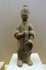 A woman with a broom and dustpan, unearthed from a tomb of Cuiping Mountain, Yibin, Sichuan