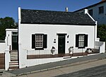 A single storey cottage with a slate roof and cottage paned sash windows. A declared national monument. Architectural style: Georgian. Type of site: House.