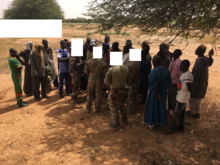 US forces with the Tongo Tongo elder and other villagers An elder of Tongo Tongo with 27 villagers approached the US forces.png