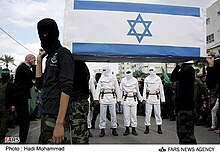 Hamas members parade with a coffin bearing the Israeli flag. Hamas has consistently called for the destruction of Israel and carried out terror attacks as part of this agenda. Parade of Palestinian Mujahideen (05).jpg