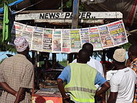 Newspapers in Tanzania Perusing Papers at a Newsstand - Near Mwenge - Tanzania.jpg