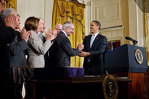 President Barack Obama shakes hands with Senat...