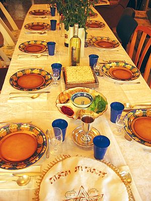 English: Festive Seder table with wine, matza ...