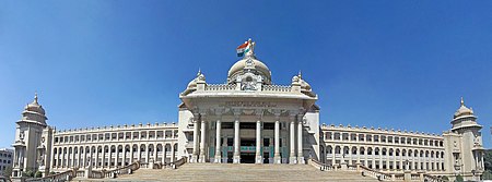 Photo of Bangalore parliament building with 18 archway columns and 10-column entrance under dome with 2 spire towers