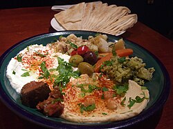 Labneh and Hummus , served with pita bread . All are common Middle ...